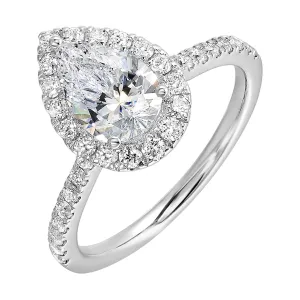 The pear cut solitare shines in this elegant ring, embraced by a delicate halo. The diamond shank adds a touch of sparkle, showcasing the beauty of the pear and halo at its finest.